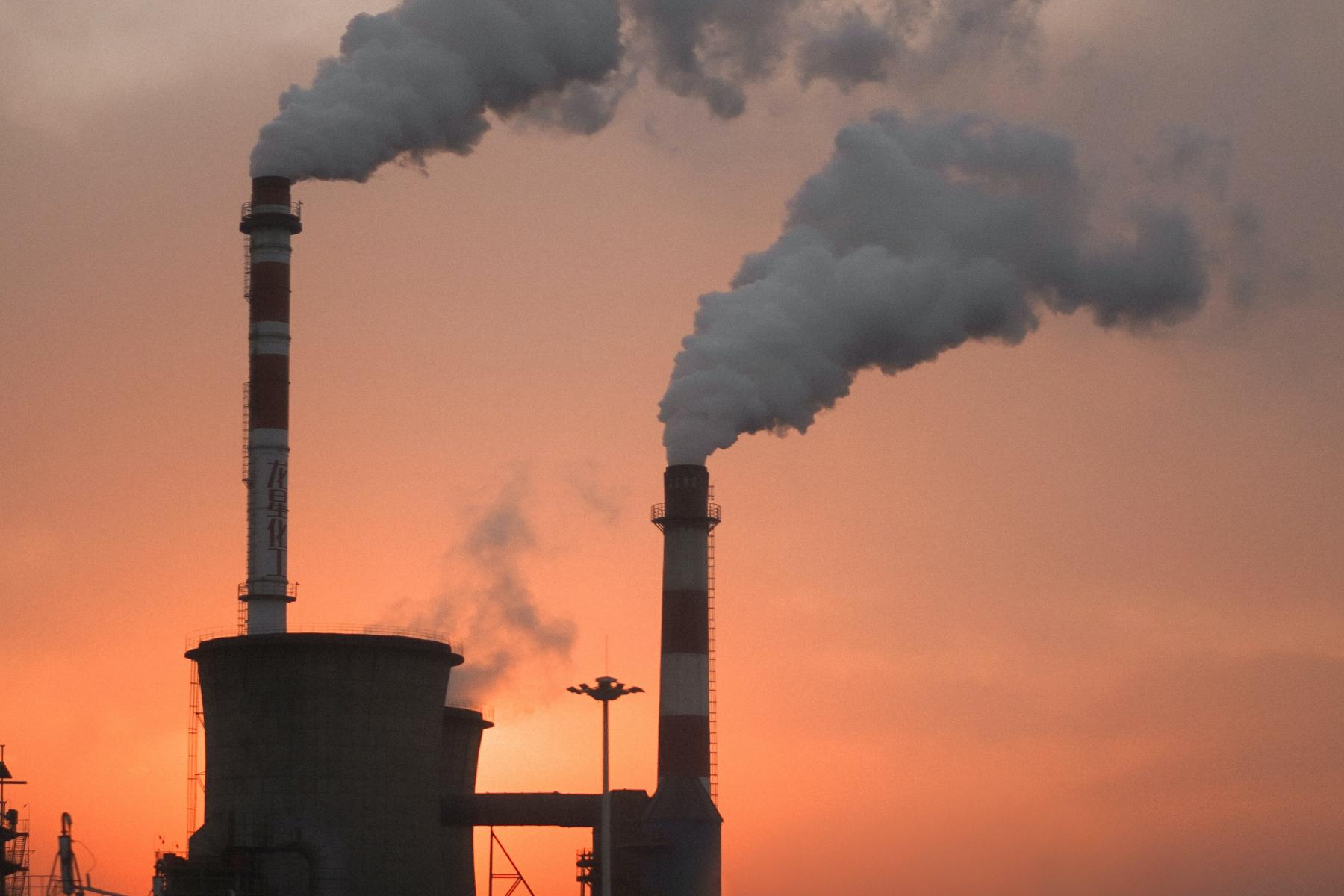 Factory producing smokes, photo by Alexander Tsang on Unsplash